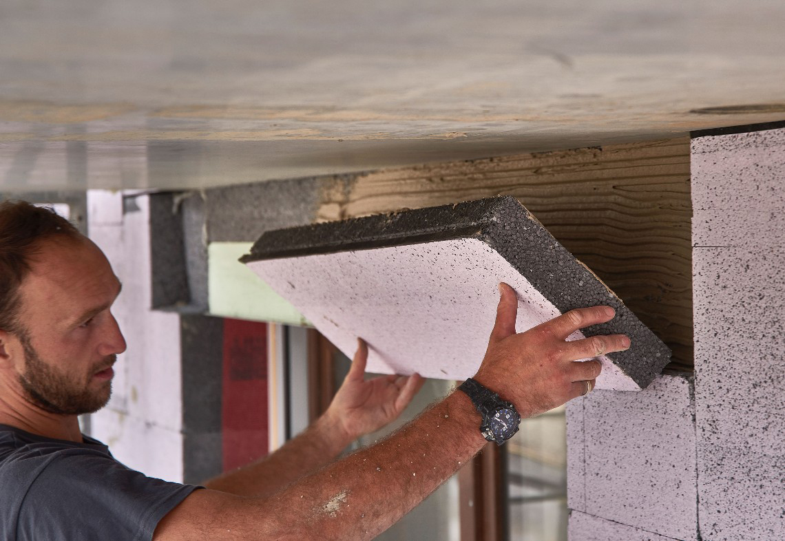 a man installs a facade insulation